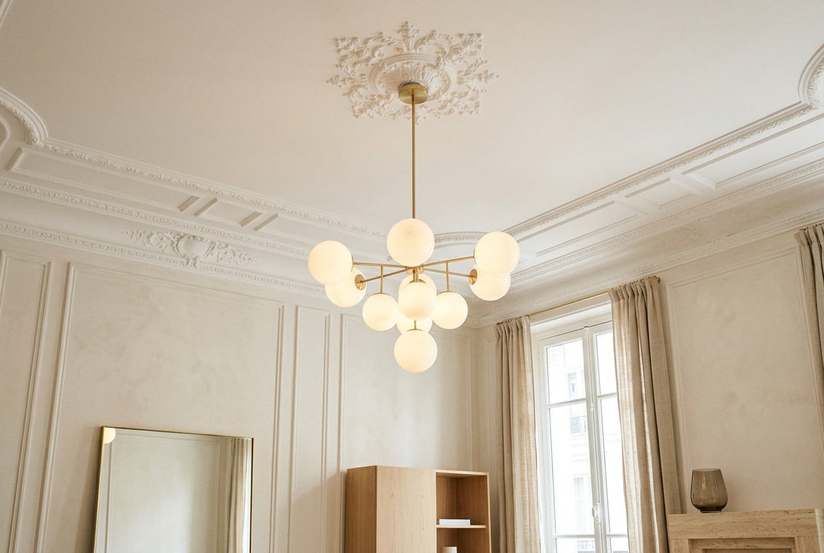 Opal globe ceiling light glowing in a living room with moldings