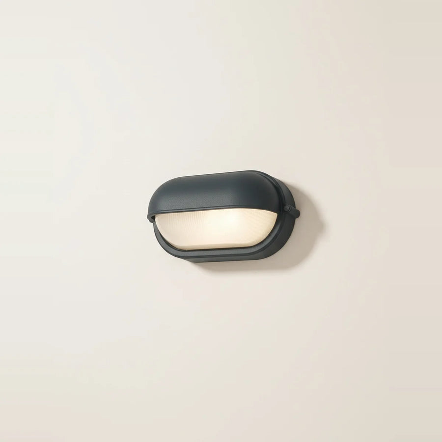Anthracite Oval Bulkhead Outdoor Light, Ribbed Glass, IP54, on a light background