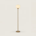 White Opal Glass Globe Floor Lamp, Gold Stem, 63 in, on a light background