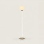 White Opal Glass Globe Floor Lamp, Gold Stem, 63 in, on a light background