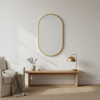Gold Oval Mirror with Thin Aluminum Frame, styled in a bright interior