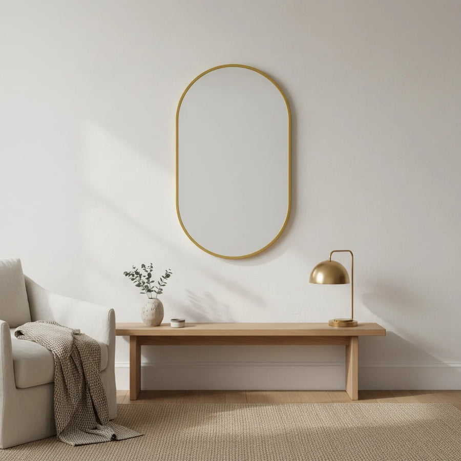 Gold Oval Mirror with Thin Aluminum Frame, styled in a bright interior