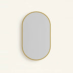 Gold Oval Mirror with Thin Aluminum Frame, on a light background
