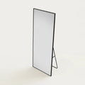 Long Black Mirror, 64.5 × 21 in Aluminum Frame, on a light background