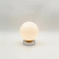 Globe Table Lamp, White Opal Glass on a Metal Base, 3 Light Tones, on a light background