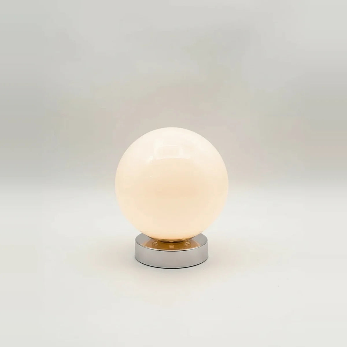 Globe Table Lamp, White Opal Glass on a Metal Base, 3 Light Tones, on a light background