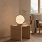 Globe Table Lamp, White Opal Glass on a Metal Base, 3 Light Tones, styled on a side table