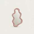 Small Pink Wavy Mirror, on a light background