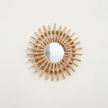 Handwoven Rattan Sun Mirror, on a light background