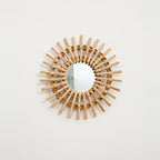 Handwoven Rattan Sun Mirror, on a light background