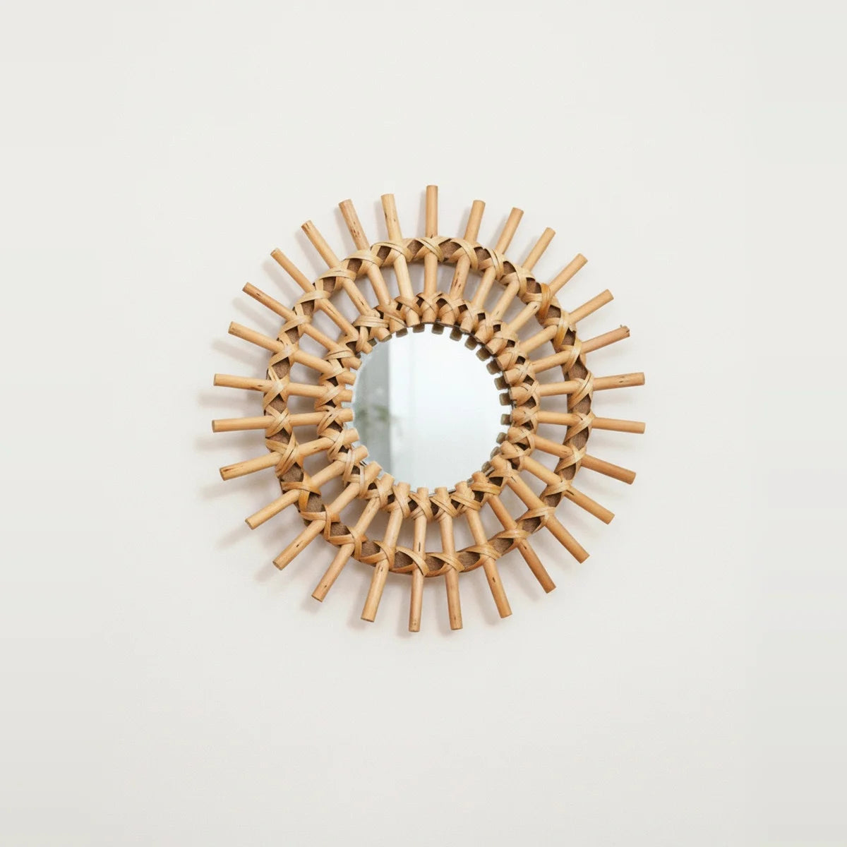 Handwoven Rattan Sun Mirror, on a light background