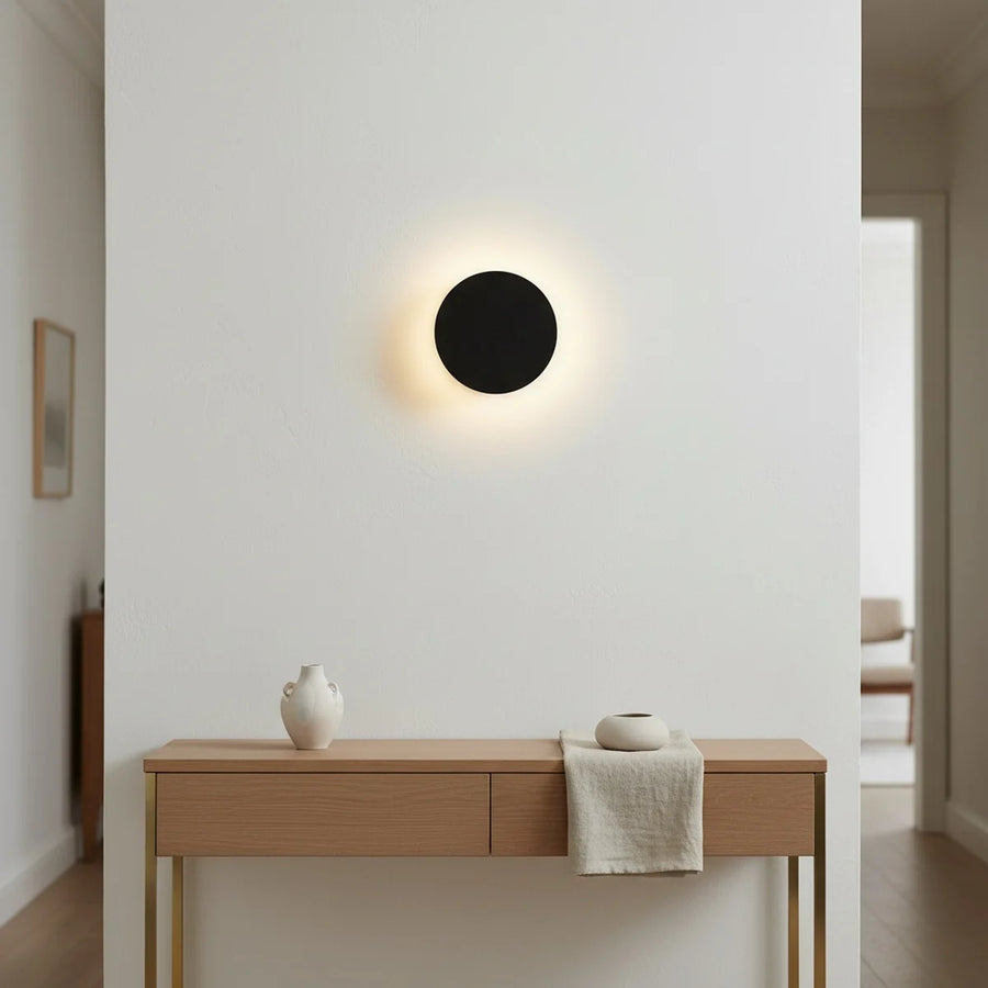 Round Black LED Wall Sconce, 5 in, Halo Backlight, styled in a hallway