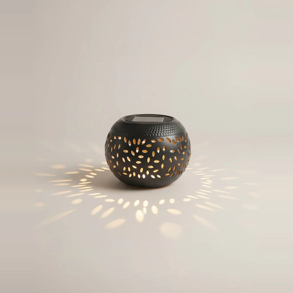 Solar Outdoor Table Lamp, Black Cut-Out Metal Lantern, on a light background