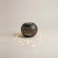 Solar Outdoor Table Lamp, Black Cut-Out Metal Lantern, on a light background