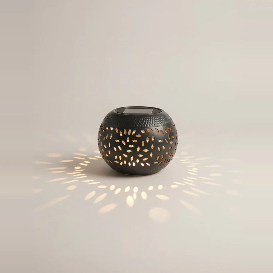 Solar Outdoor Table Lamp, Black Cut-Out Metal Lantern, on a light background