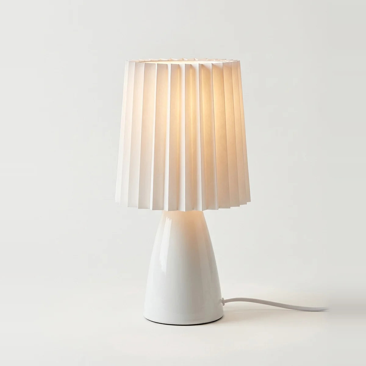 Ceramic Table Lamp, White, Pleated Fabric Shade, on a light background