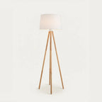 Wooden Tripod Floor Lamp with White Fabric Shade, on a light background